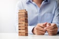 Businessman hand placing or pulling wooden block on the tower. Business planning, Risk Management, Solution and strategy Concepts Royalty Free Stock Photo