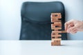 Businessman hand placing or pulling wooden block on the tower. Business planning, Risk Management, Solution and strategy Concepts Royalty Free Stock Photo