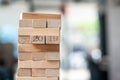 Businessman hand placing or pulling wooden block on the tower. Business planning, Risk Management Royalty Free Stock Photo