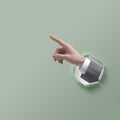Businessman hand pointing through a hole in paper Royalty Free Stock Photo