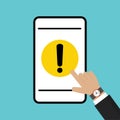 Businessman hand pointing at mobile phone icon with yellow hazard warning attention sign, exclamation mark symbol Royalty Free Stock Photo