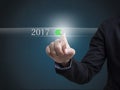 Businessman hand pressing button New Year 2017. Royalty Free Stock Photo