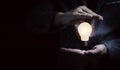 Businessman hand protecting lightbulb glowing with connection line for creative thinking ideas and innovation concept