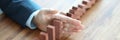 Businessman hand separates wooden blocks on table