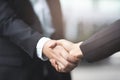 businessman hand shake businesswoman between two colleagues Royalty Free Stock Photo