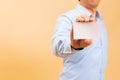 Businessman hand showing empty white business card in yellow background