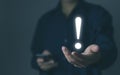 businessman hand showing exclamation point business development ideas Warning of errors, dangers, alerts, maintenance, And finding Royalty Free Stock Photo