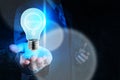 Businessman hand showing light bulb with gear Royalty Free Stock Photo