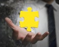 Businessman hand showing one 3D gold jigsaw puzzle piece Royalty Free Stock Photo