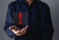 Businessman hand showing red exclamation mark, business development concept Error warning, danger, notification, maintenance and Royalty Free Stock Photo