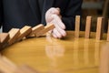 businessman hand stop dominoes continuous toppled or risk with c Royalty Free Stock Photo