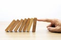 Businessman hand stoped wooden domino effect. Royalty Free Stock Photo