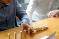 Businessman hand stopping the domino effect. executive and risk Royalty Free Stock Photo