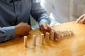 Businessman hand stopping the domino effect. executive and risk Royalty Free Stock Photo