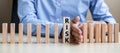 Businessman hand Stopping Falling wooden Blocks or Dominoes. Business, Risk Management, Solution, Insurance and strategy Concepts Royalty Free Stock Photo