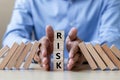 Businessman hand Stopping Falling wooden Blocks or Dominoes. Business, Risk Management, Solution, Insurance and strategy Concepts Royalty Free Stock Photo