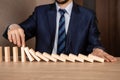 Businessman hand Stopping Falling wooden blocks. Strategy and successful intervention concept for business Royalty Free Stock Photo