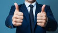 Businessman hand thumb up on blue punched paper Royalty Free Stock Photo