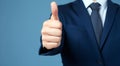 Businessman hand thumb up on blue punched paper Royalty Free Stock Photo