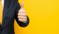 Businessman hand thumb up on yellow punched paper Royalty Free Stock Photo