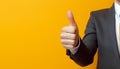 Businessman hand thumb up on yellow punched paper Royalty Free Stock Photo