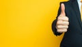 Businessman hand thumb up on yellow punched paper Royalty Free Stock Photo