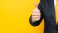 Businessman hand thumb up on yellow punched paper Royalty Free Stock Photo