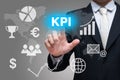 Businessman hand touch KPI symbols on gray background