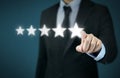 Businessman hand touching five star symbol to increase rating of company concept Royalty Free Stock Photo