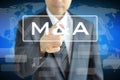 Businessman hand touching M & A on virtual screen