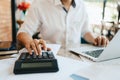 Businessman hand using calculator for calculate about cost, tax or budget on the table in office Royalty Free Stock Photo