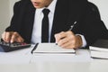 Businessman hand using calculator Calculating bonusOr other compensation to employees to increase productivity.Writing paper on Royalty Free Stock Photo