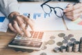 Businessman hand using calculator Calculating bonusOr other compensation to employees to increase productivity.Writing paper Royalty Free Stock Photo