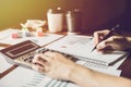 Businessman hand using calculator Calculating bonusOr other compensation to employees to increase productivity.Writing paper on Royalty Free Stock Photo