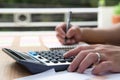 Businessman hand using calculator Calculating bonusOr other compensation to employees to increase productivity.Writing paper on Royalty Free Stock Photo