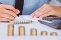 Businessman hand using calculator Calculating bonusOr other compensation to employees to increase productivity.Writing paper on Royalty Free Stock Photo