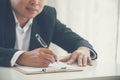 Businessman hand using pen signing on new contract starting projects in conference room. Close up business manager man hands sign Royalty Free Stock Photo