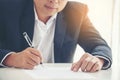 Businessman hand using pen signing on new contract to starting projects in conference room. Close up business manager man hands Royalty Free Stock Photo
