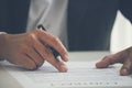 Businessman hand using pen signing on new contract to starting projects in conference room. Close up business manager man hands Royalty Free Stock Photo