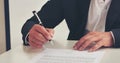 Businessman hand using pen signing on new contract to starting projects in conference room. Close up business manager man hands Royalty Free Stock Photo