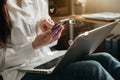 Businessman hand using smartphone and laptop at home. Digital marketing media mobile app in virtual icon screen Royalty Free Stock Photo