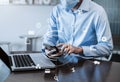 Businessman hand working with laptop computer and smart phone in modern office with virtual icon diagram at modern office Royalty Free Stock Photo