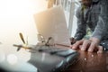 businessman hand working with new modern computer and smart phone and business strategy document on wooden desk with calculator Royalty Free Stock Photo