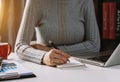 Businessman hand working with new modern computer and writing on the notepad strategy diagram as concept Royalty Free Stock Photo