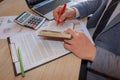 Businessman hand working with new modern computer and writing on the notepad strategy diagram as concept morning light Royalty Free Stock Photo