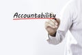 Businessman hand writing Accountability with red marker on trans