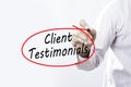 Businessman Hand Writing Client Testimonials with a marker over