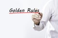 Businessman hand writing Golden Rules with red marker on transparent wipe board, business concept Royalty Free Stock Photo
