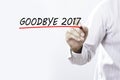 Businessman hand writing goodbye 2017 with red marker on transparent wipe board, business concept Royalty Free Stock Photo