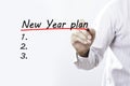 Businessman hand writing New year plan with red marker on transparent wipe board, business concept Royalty Free Stock Photo